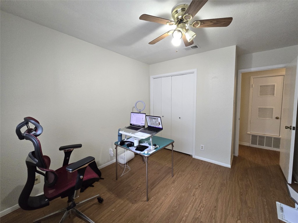 2600 Penny Lane, Unit 212 Austin, TX 78757 - Photo 15 of 35 a room with gym equipment and wooden floor