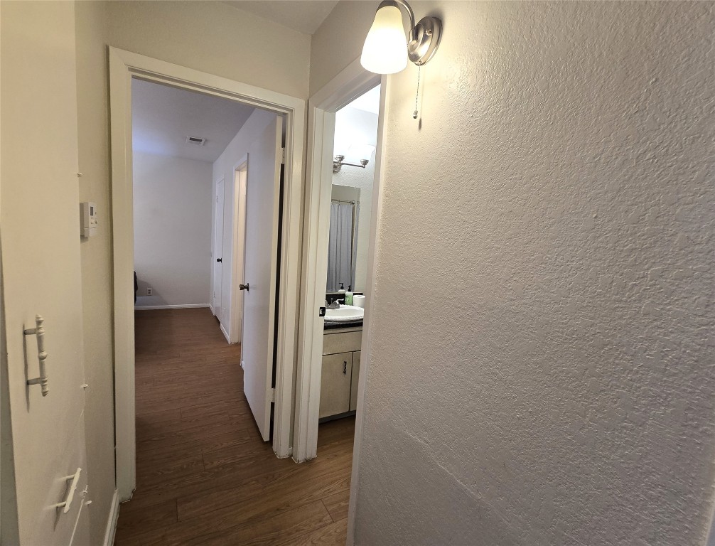 2600 Penny Lane, Unit 212 Austin, TX 78757 - Photo 16 of 35 Bedroom #2 view of hallway, doors to full bathroom and primary bedroom