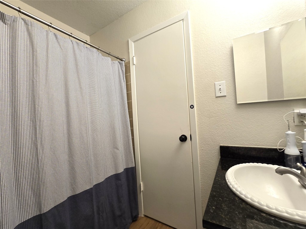 2600 Penny Lane, Unit 212 Austin, TX 78757 - Photo 18 of 35 a bathroom with a sink and a mirror