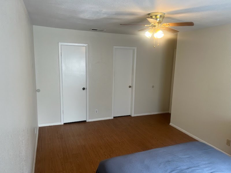2600 Penny Lane, Unit 212 Austin, TX 78757 - Photo 22 of 35 Primary Bedroom - view of doors to bathroom and walk-in closet