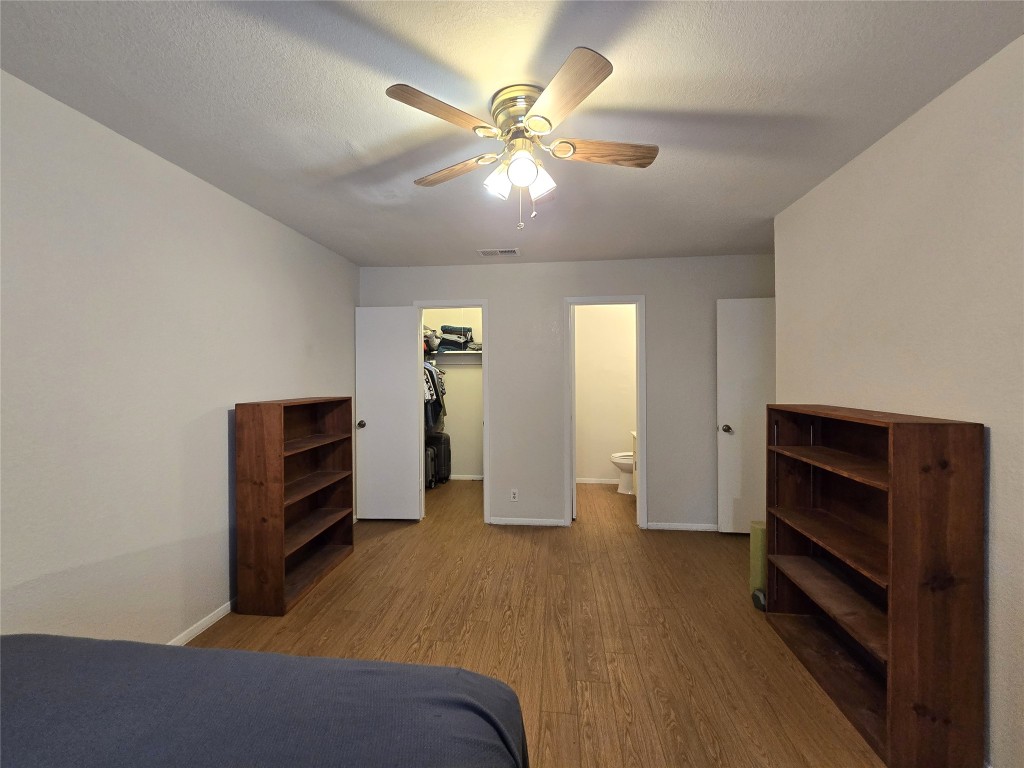 2600 Penny Lane, Unit 212 Austin, TX 78757 - Photo 23 of 35 Primary Bedroom - view of doors to bathroom and walk-in closet