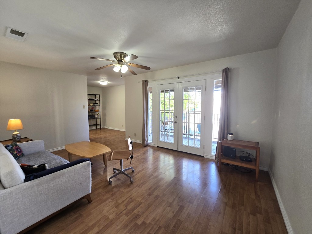 2600 Penny Lane, Unit 212 Austin, TX 78757 - Photo 26 of 35 a living room with furniture and wooden floor