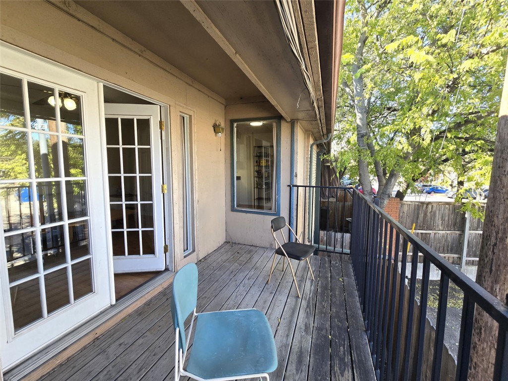 2600 Penny Lane, Unit 212 Austin, TX 78757 - Photo 28 of 35 a view of balcony with wooden floor and fence and a potted plant