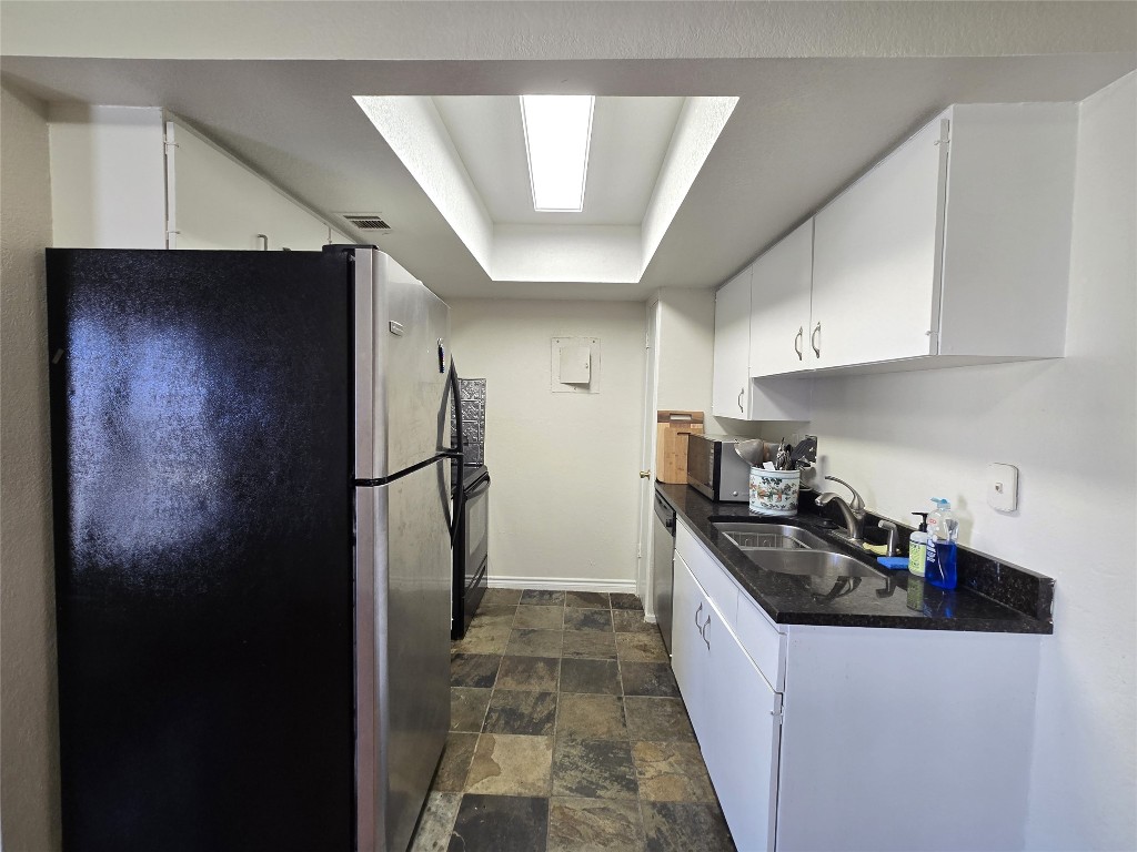 2600 Penny Lane, Unit 212 Austin, TX 78757 - Photo 7 of 35 a kitchen with a refrigerator and a sink