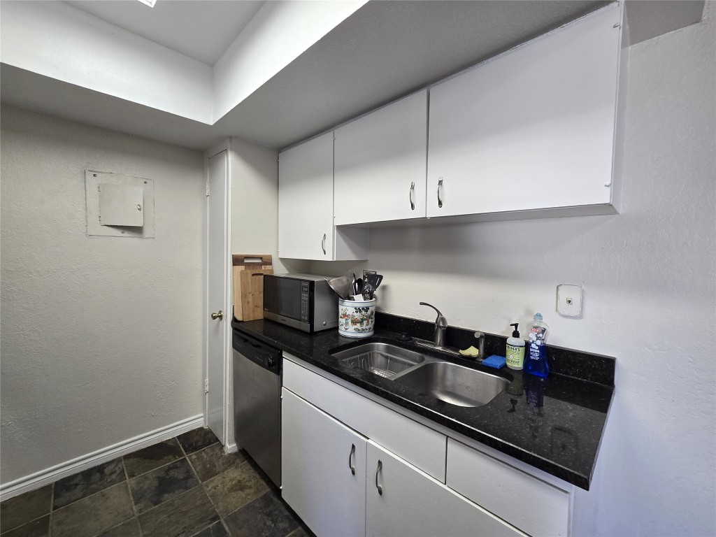 2600 Penny Lane, Unit 212 Austin, TX 78757 - Photo 9 of 35 a kitchen with a sink and cabinets