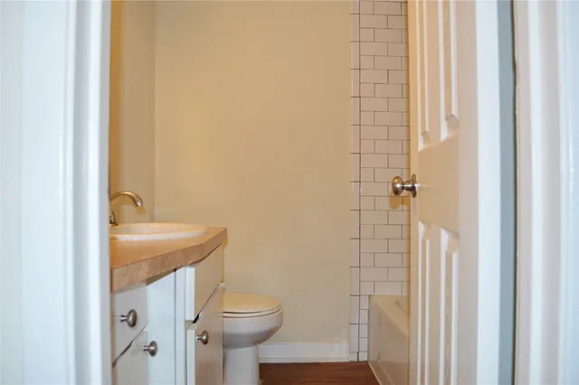 a bathroom with a granite countertop sink toilet and shower