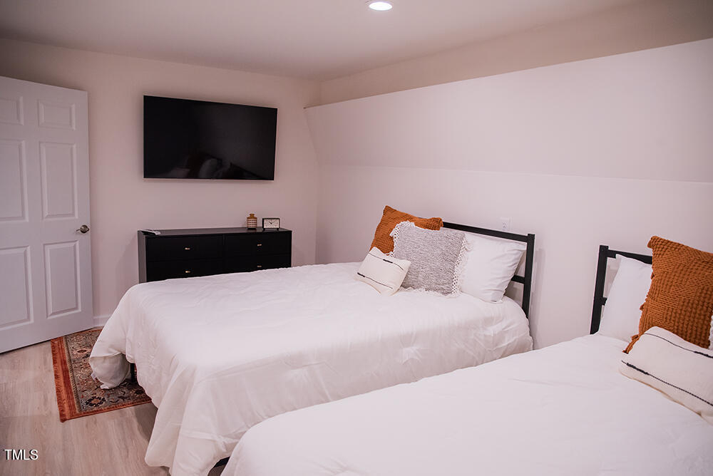 1423 Concord Church Road Roxboro, NC 27574 - Photo 54 of 78 a bedroom with a bed and a flat tv screen on dresser