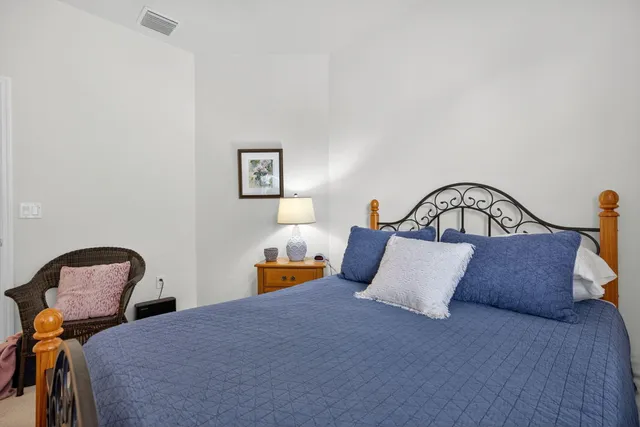 a bedroom with a bed and a table in it