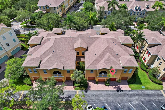 an aerial view of multiple houses with yard