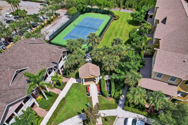 an aerial view of multiple houses with yard
