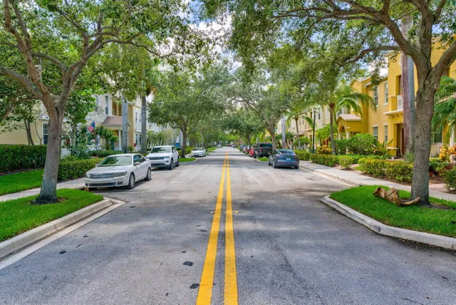 a view of a street with cars parked