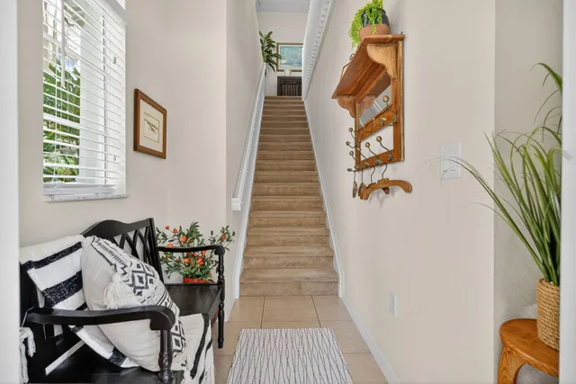 a view of a hallway to a livingroom with furniture