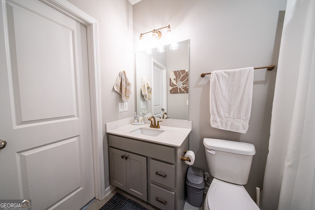 62 James Creek Road Fortson, GA 31808 - Photo 23 of 49 a bathroom with a toilet sink and mirror