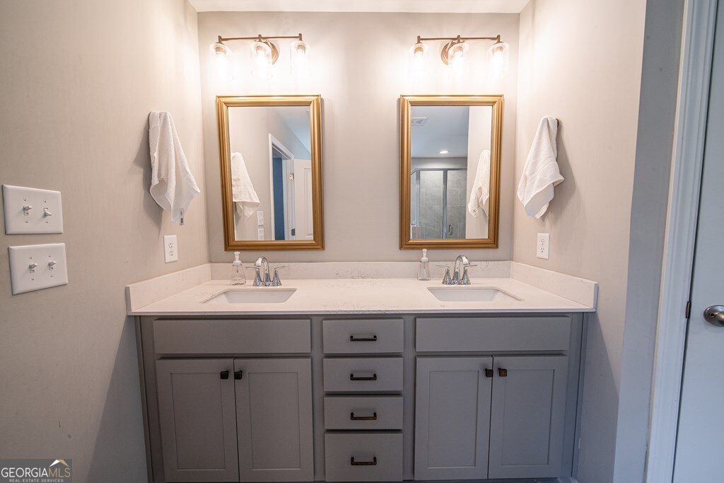 62 James Creek Road Fortson, GA 31808 - Photo 31 of 49 a bathroom with 2 sink and a mirror