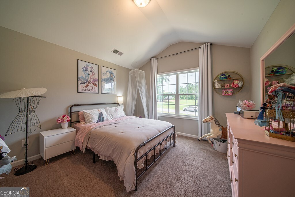 62 James Creek Road Fortson, GA 31808 - Photo 37 of 49 a spacious bedroom with a bed a couch and a window