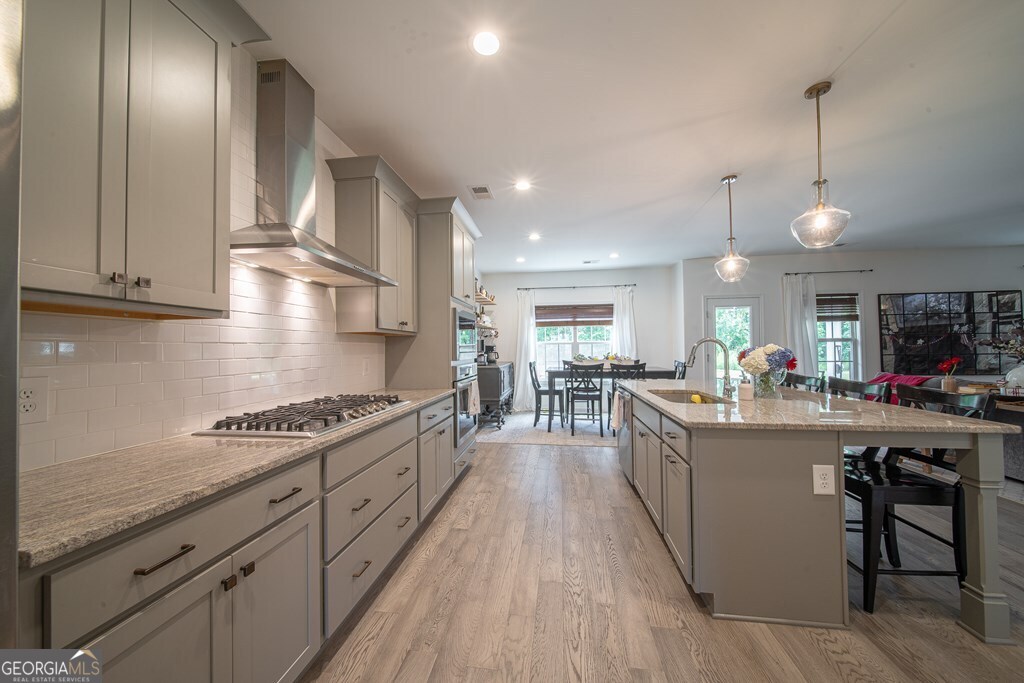 62 James Creek Road Fortson, GA 31808 - Photo 9 of 49 a kitchen with stainless steel appliances granite countertop a lot of counter space and wooden floors