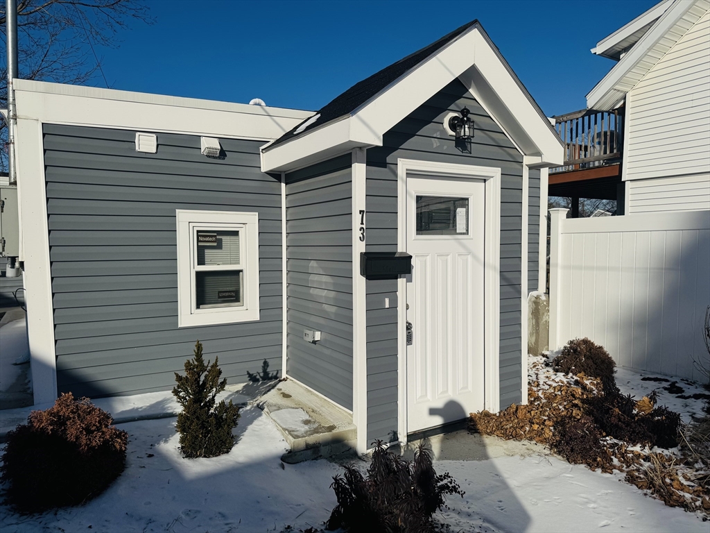 73 Victoria Street Revere, MA 02151 - Photo 1 of 24 a front view of a house with a yard
