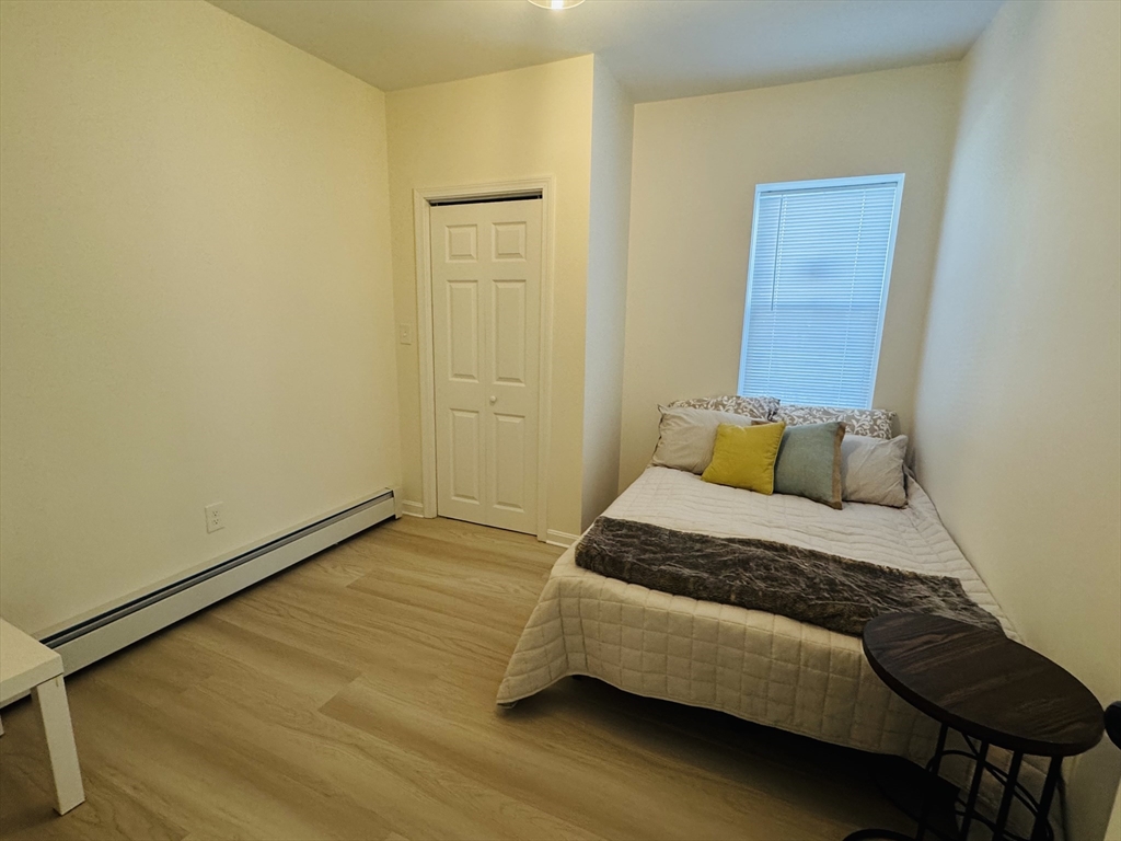 73 Victoria Street Revere, MA 02151 - Photo 13 of 24 a bedroom with a bed and wooden floor