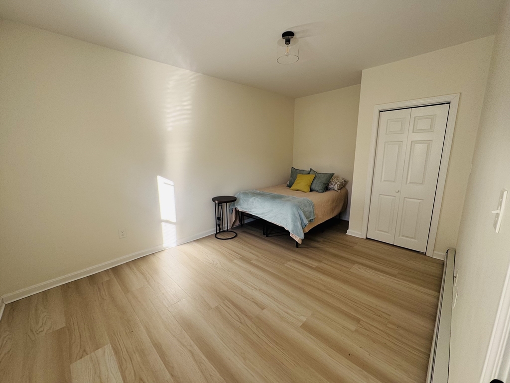 73 Victoria Street Revere, MA 02151 - Photo 14 of 24 an empty room with wooden floor and windows