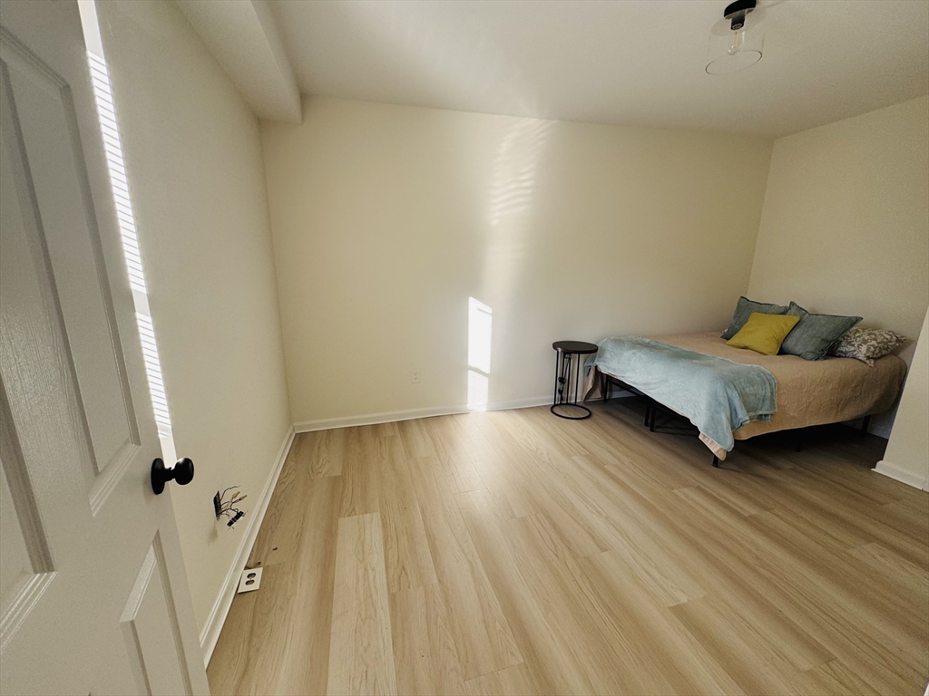 73 Victoria Street Revere, MA 02151 - Photo 15 of 24 a bedroom with a bed and wooden floor
