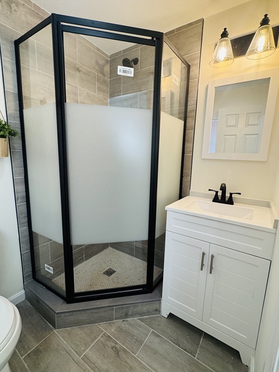 73 Victoria Street Revere, MA 02151 - Photo 18 of 24 a bathroom with a mirror and a shower