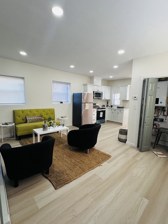73 Victoria Street Revere, MA 02151 - Photo 7 of 24 a living room with furniture and a wooden floor