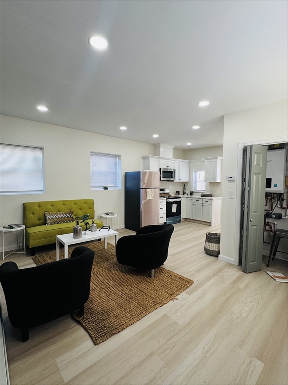 73 Victoria Street Revere, MA 02151 - Photo 8 of 24 a living room with furniture and kitchen view