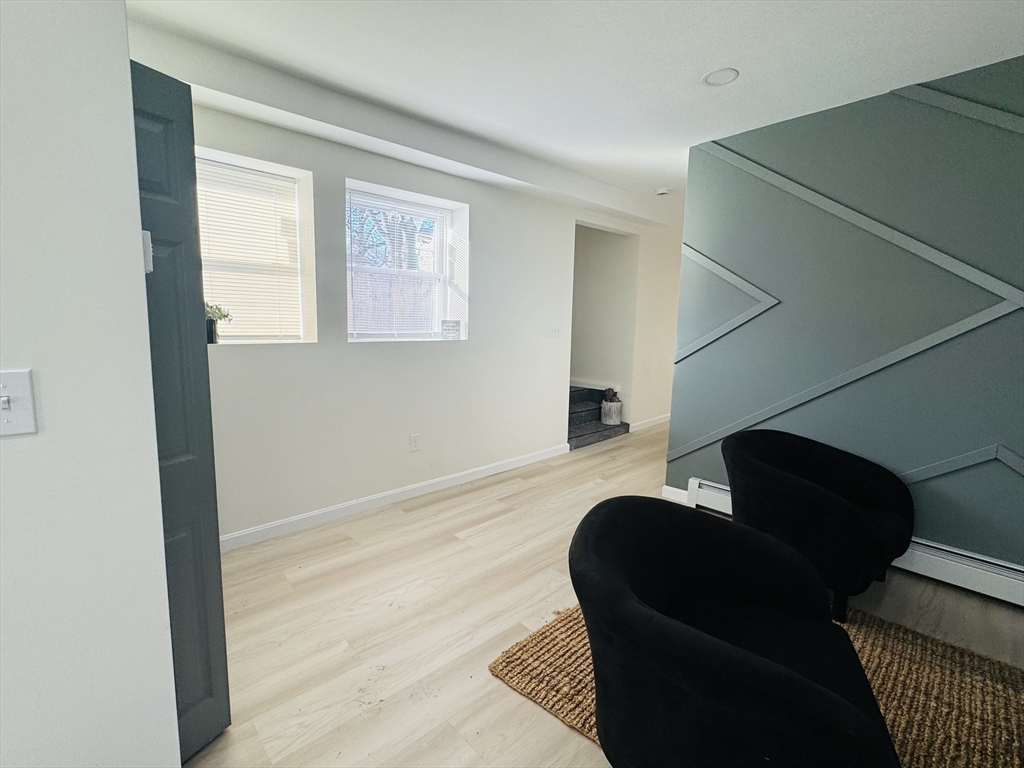 73 Victoria Street Revere, MA 02151 - Photo 10 of 24 a living room with furniture and a window
