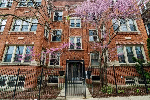 a front view of a residential apartment building with a yard