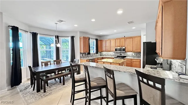 a large kitchen with a table and chairs