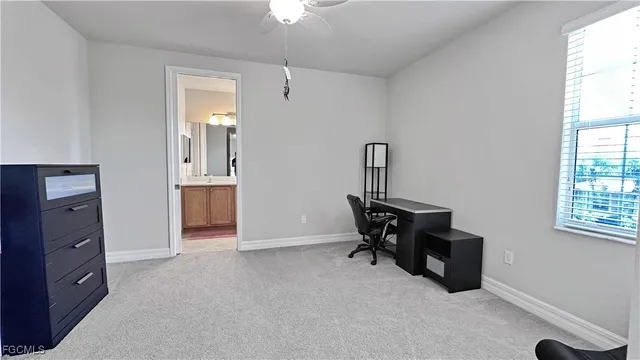 an empty room with windows and cabinet