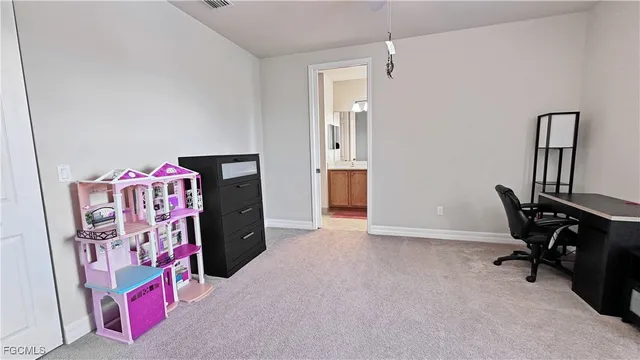 a view of a bedroom with workspace and a window