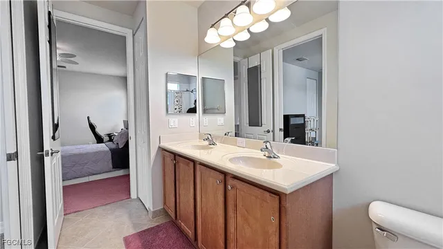 a en suite bathroom with a sink and a mirror