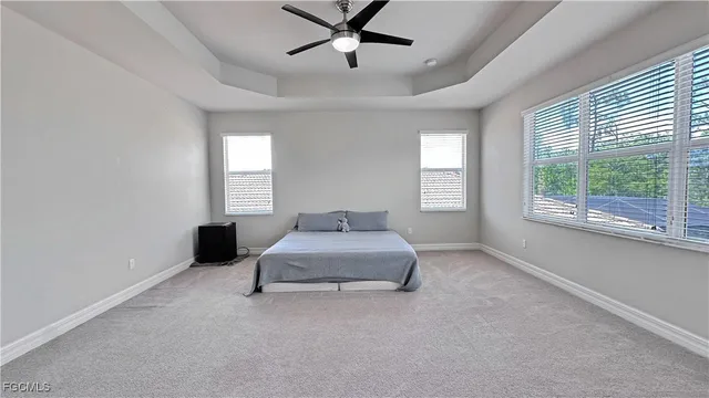a spacious bedroom with a bed and window