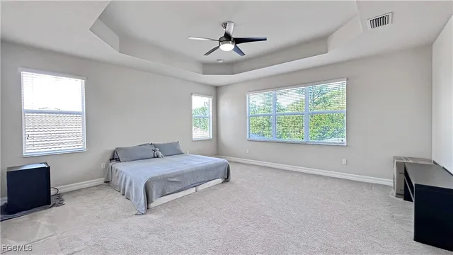 a spacious bedroom with a bed and a window