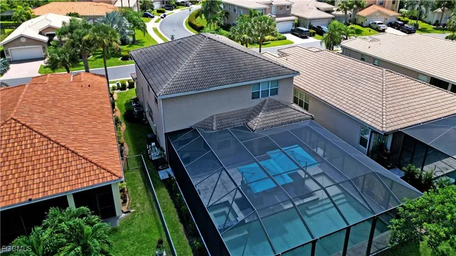 an aerial view of a house with a yard and potted plants