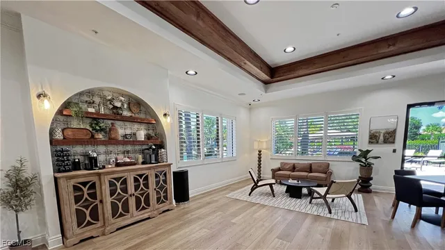 a living room with furniture a window and wooden floors