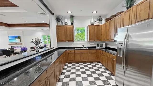 a kitchen with a refrigerator a sink and cabinets
