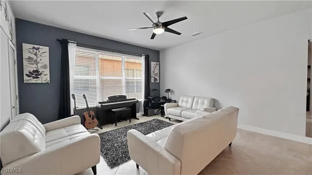 a living room with furniture and a large window with garden view