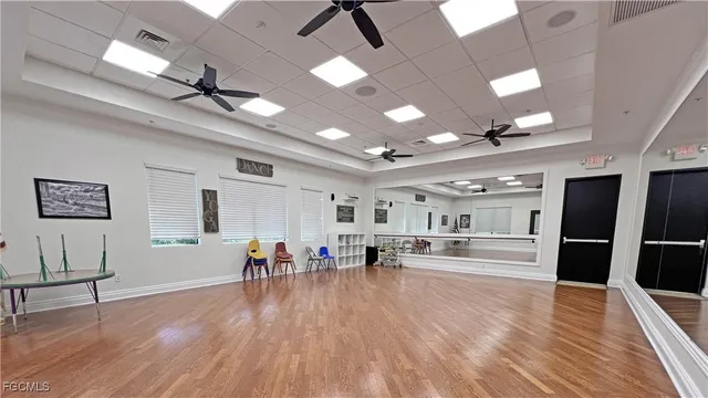 a view of a kitchen with refrigerator and wooden floor