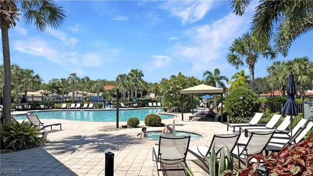 a view of swimming pool with outdoor seating and plants