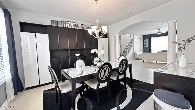 a view of a dining room with furniture and chandelier