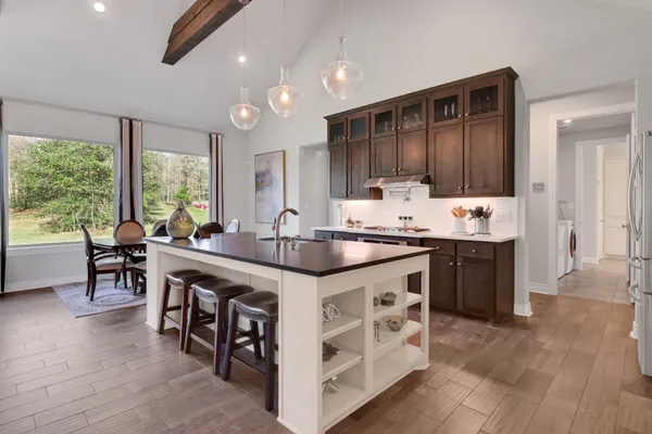 a view of a patio with couches chairs potted plants and floor to ceiling window