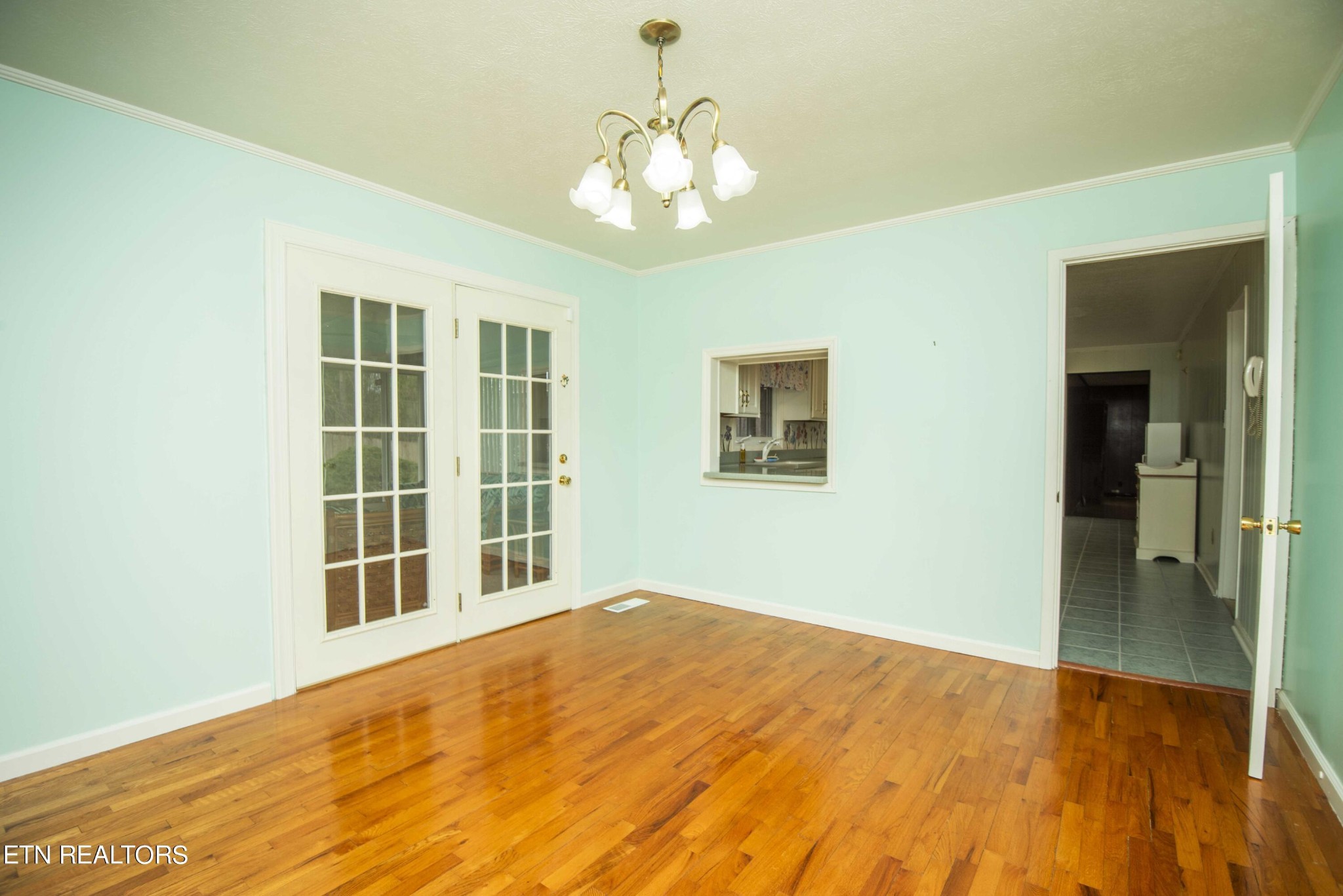 1280 Laurel Road Clinton, TN 37716 - Photo 14 of 36 a view of an empty room with wooden floor and a chandelier