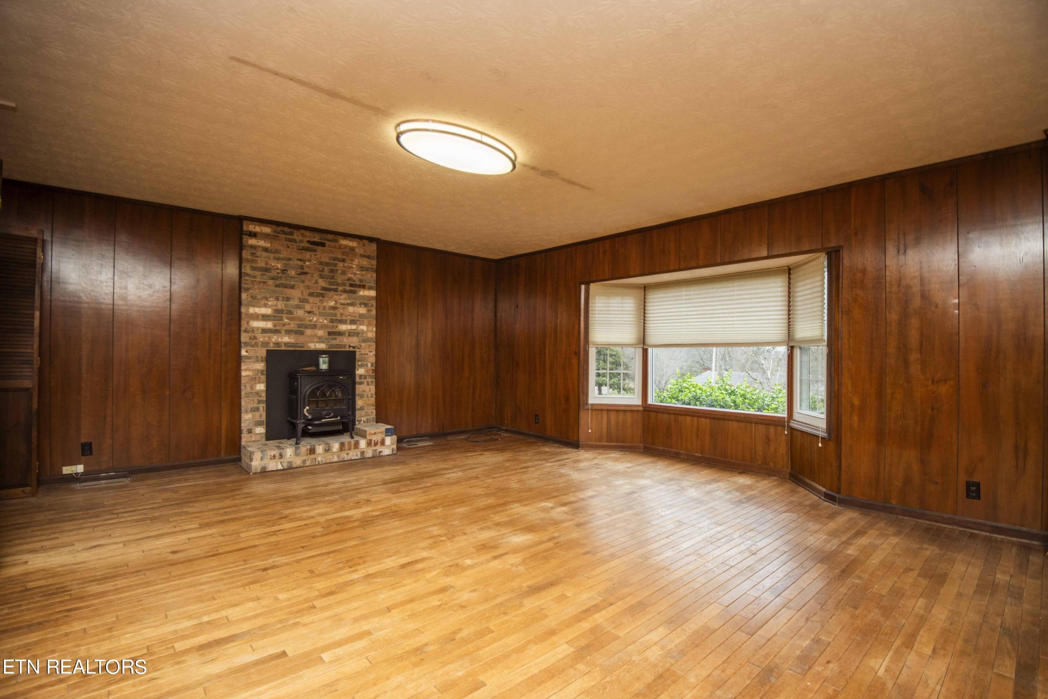 1280 Laurel Road Clinton, TN 37716 - Photo 19 of 36 a view of an empty room with a fireplace and a window