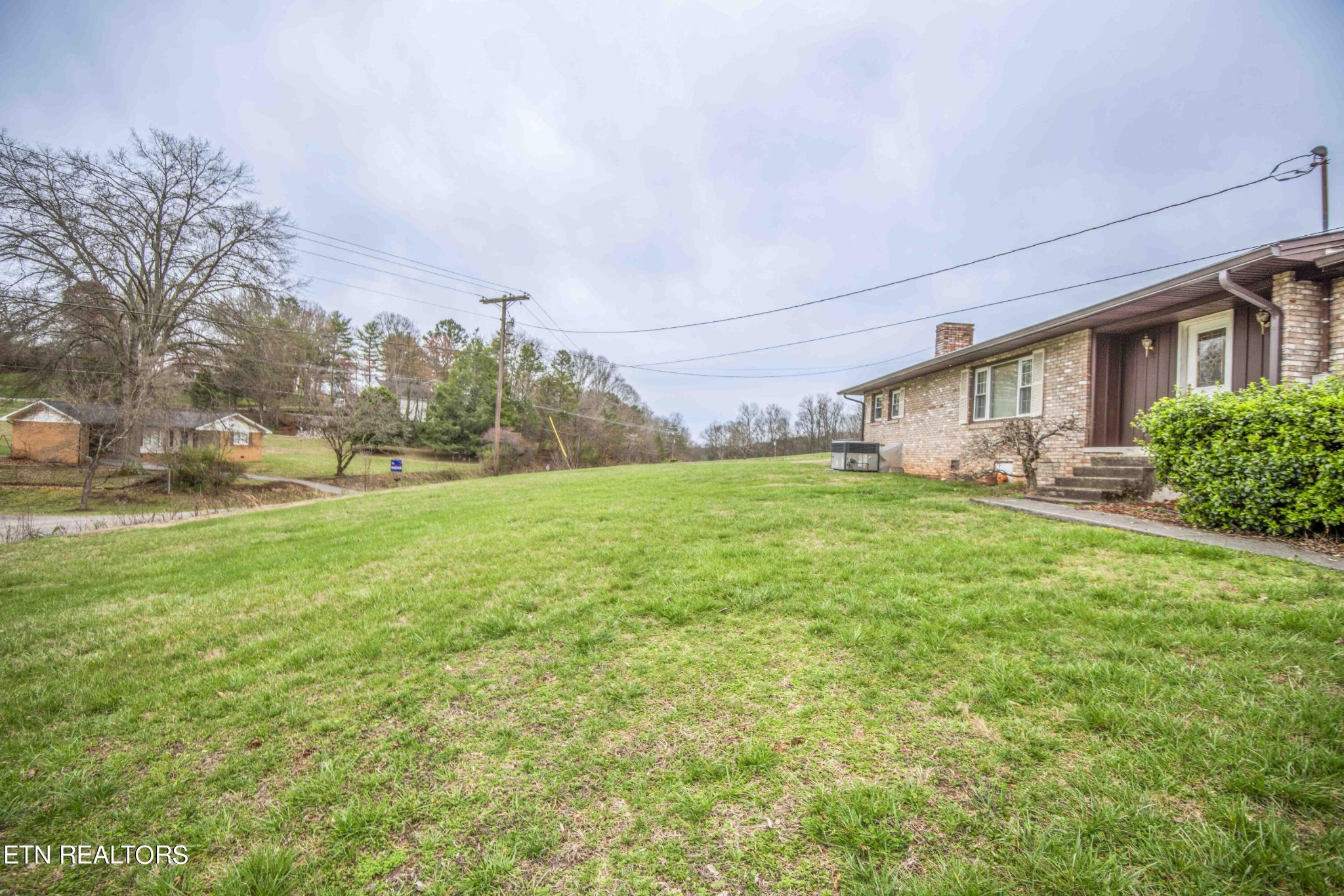 1280 Laurel Road Clinton, TN 37716 - Photo 33 of 36 a view of a house with a big yard and large trees