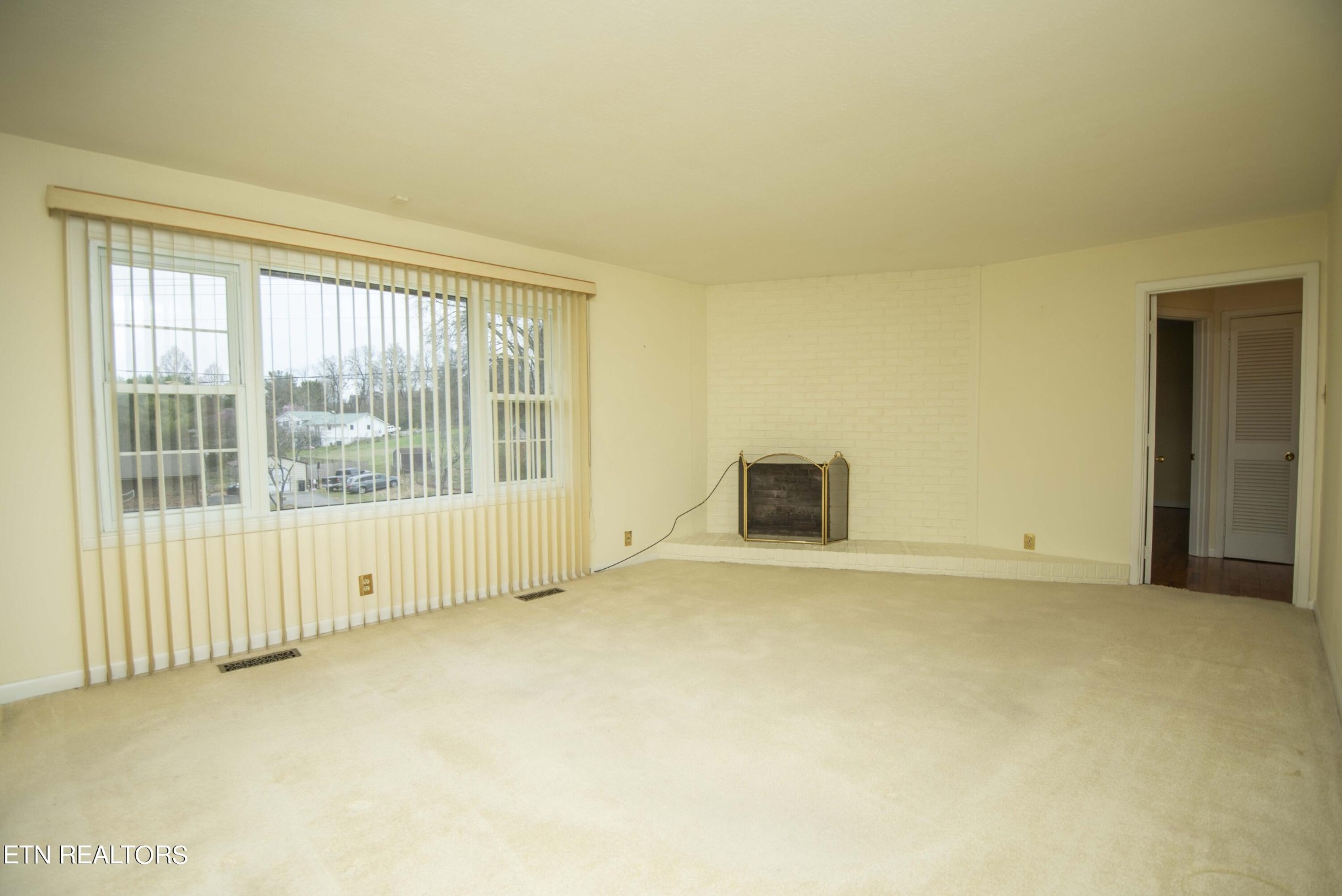 1280 Laurel Road Clinton, TN 37716 - Photo 9 of 36 an empty room with floor to ceiling windows