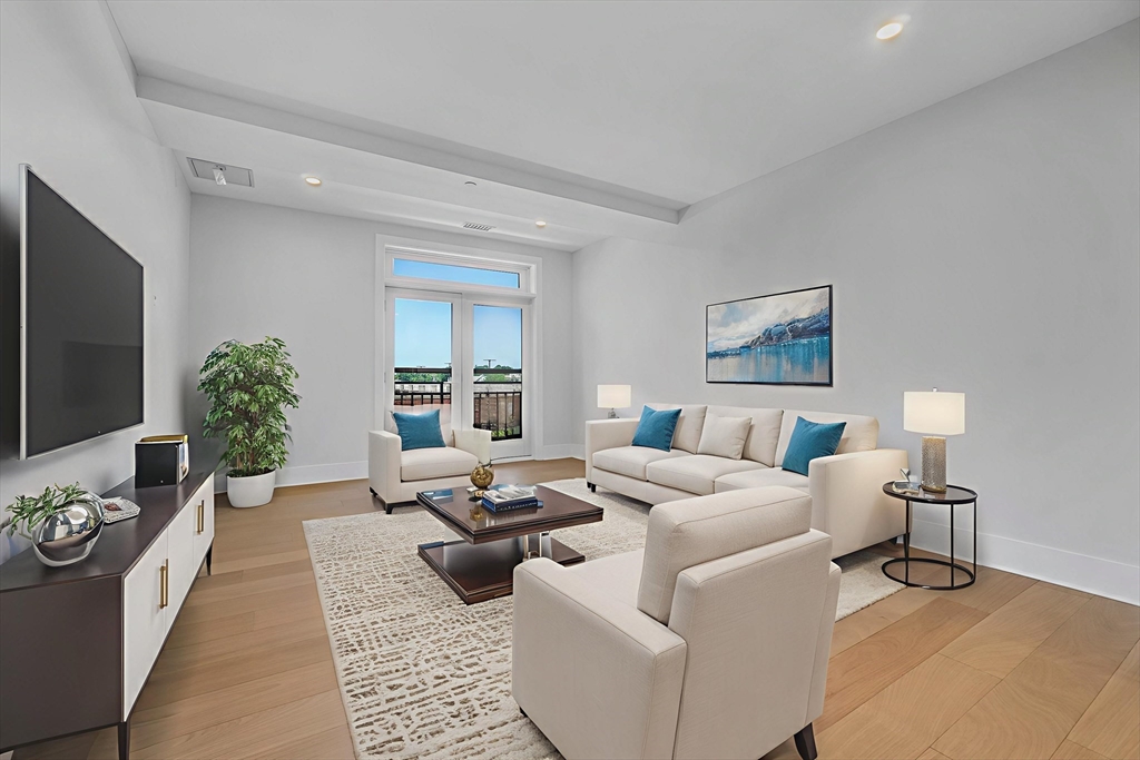 62 Foundry Street, Unit 414 Wakefield, MA 01880 - Photo 1 of 24 a living room with furniture and a flat screen tv