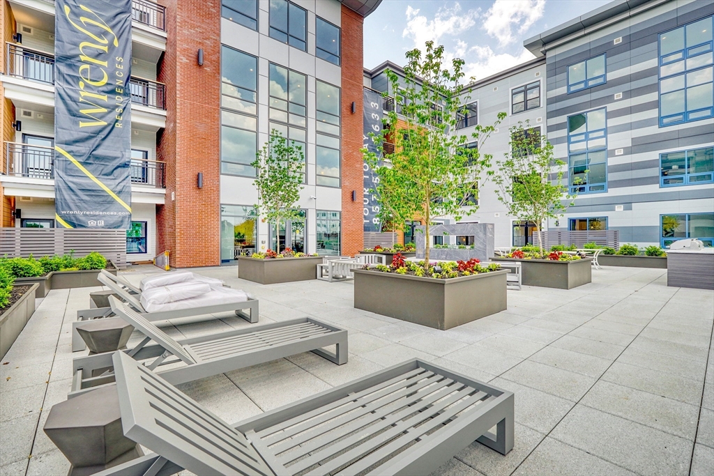 62 Foundry Street, Unit 414 Wakefield, MA 01880 - Photo 13 of 24 a building outdoor space with patio furniture