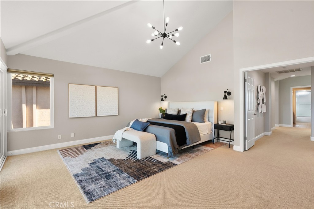 8 Rimani Drive Mission Viejo, CA 92692 - Photo 19 of 56 a spacious bedroom with a bed a dresser and windows